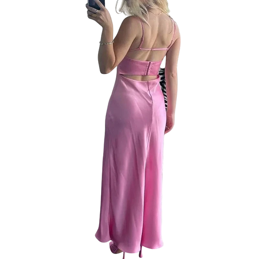 JunoJ pink satin slip maxi dress with spaghetti straps and back cutout detail. Elegant evening wear.
